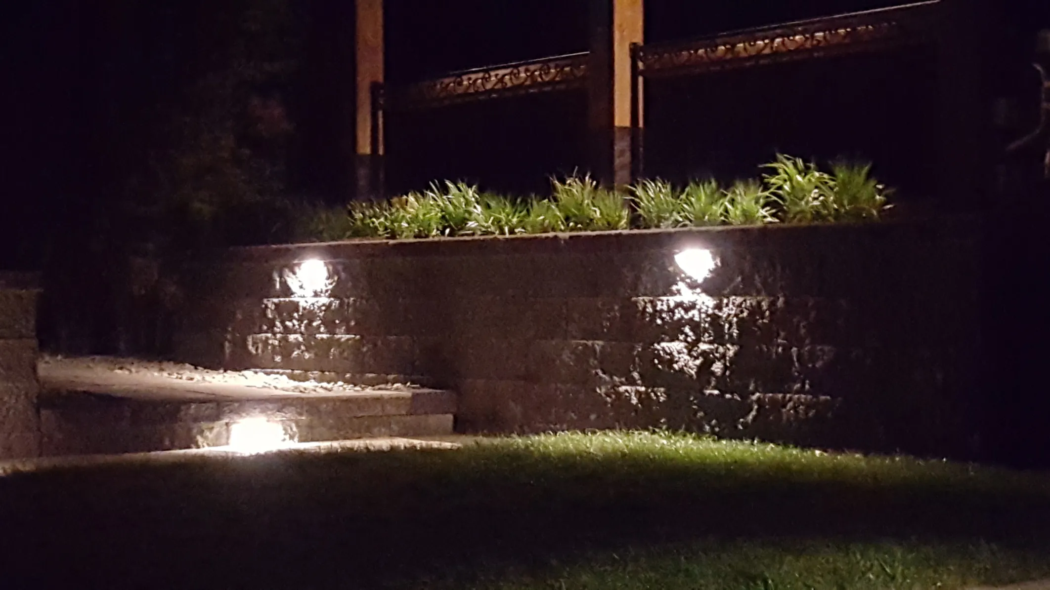 Custom landscape lighting design with LED spotlights and pathway illumination in Osoyoos
