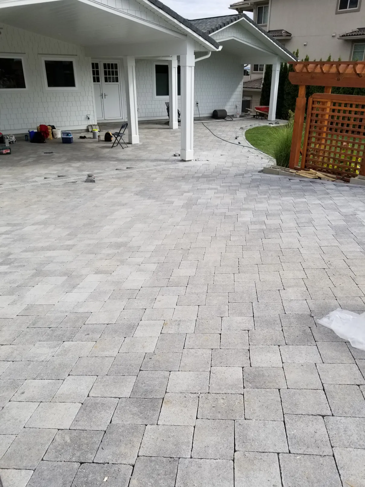 Happy homeowner with completed landscaping project in Osoyoos BC