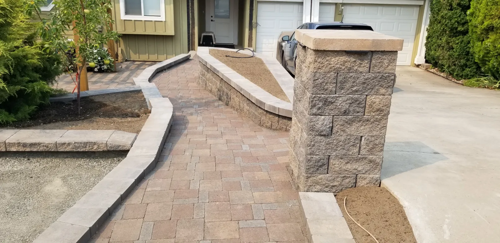 Belgard interlocking paver patio with decorative border and polymeric sand joints in Osoyoos BC