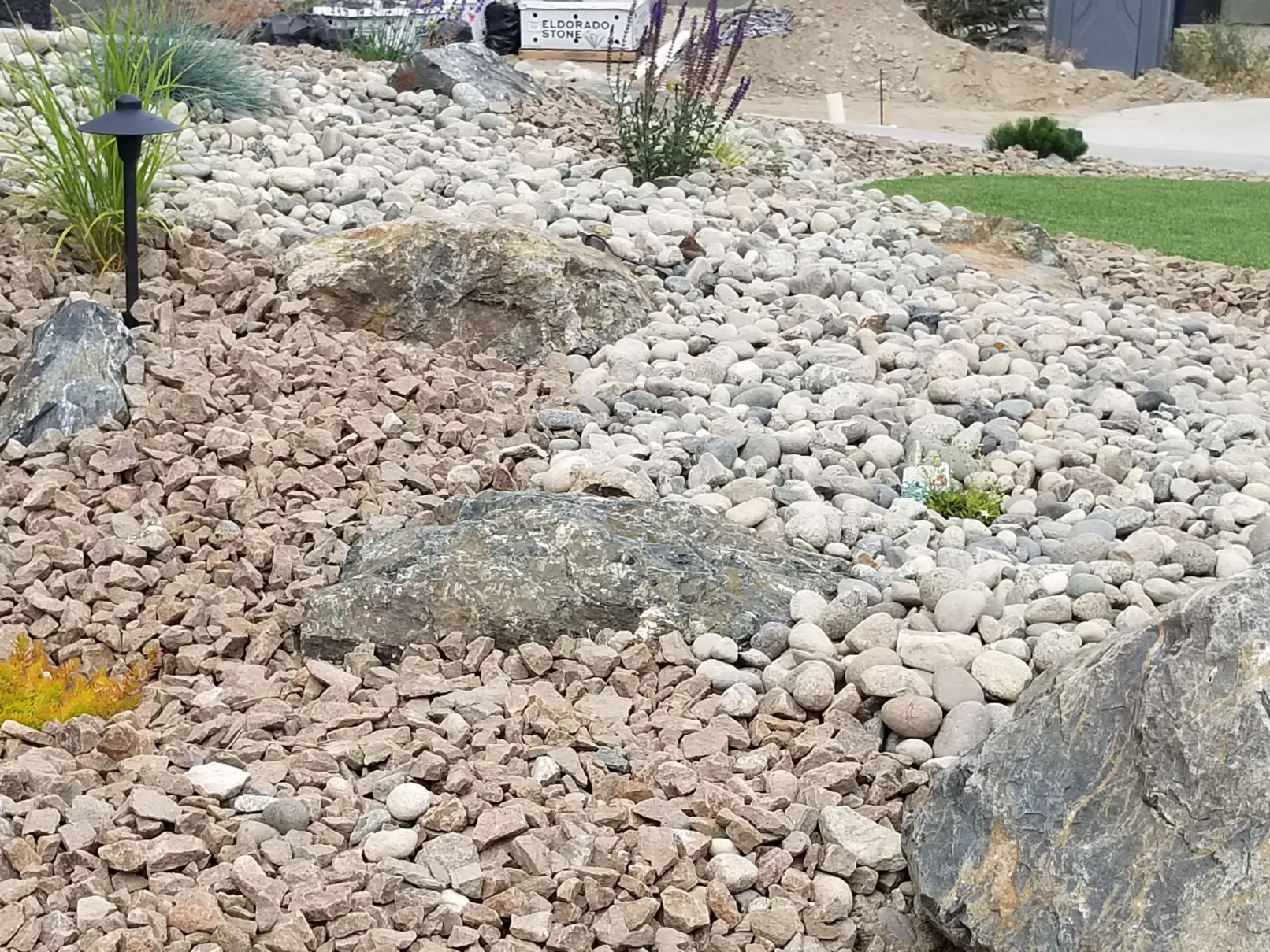 Professional xeriscape garden with decorative rock mulch and drought-tolerant plants in Osoyoos BC